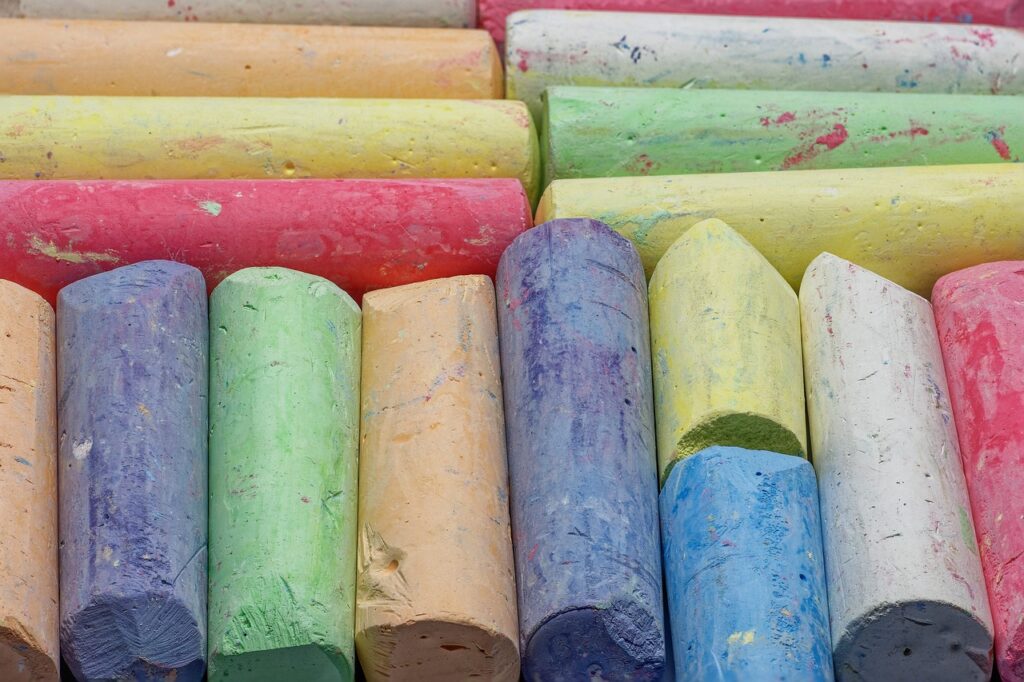 Multi-coloured chalks all lined up, ready to be used