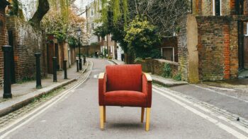 A red armchair placed in the middle of the street, old brick houses on either side. This is the place to stop and take stock, part way on the journey to success.