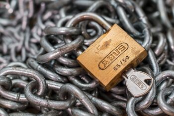A padlock on some chains. What's holding you back? What's in the way? What do you overcome to grow and develop?