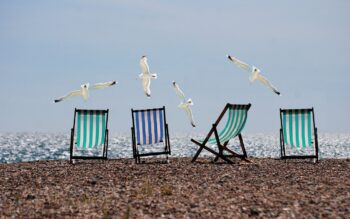 Deckchairs on a beach. What does the summer give you that you want all of the time?