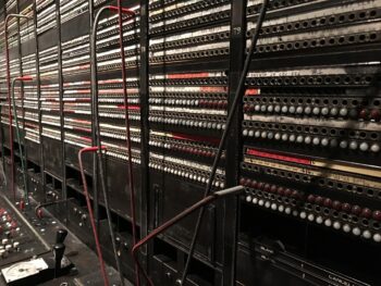 An old-fashioned switchboard, cables everywhere. So easy to get your wires crossed, and so import communicate well.