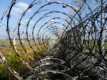 Razor-wire blocking the way. One route may be closed and it's all about finding a different way.