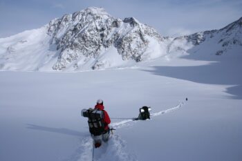Hiking in the snow, two people are creating a path. You, too, can find your way.