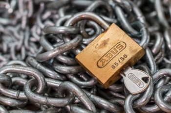 A padlock, locking chains in place. Are you locking yourself out of your future?