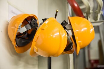 Hardhats, in bright yellow, hanging from hooks. It's time to do the work.
