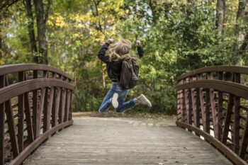 A child jumping for joy on a bridge. What makes you want to jump for joy?
