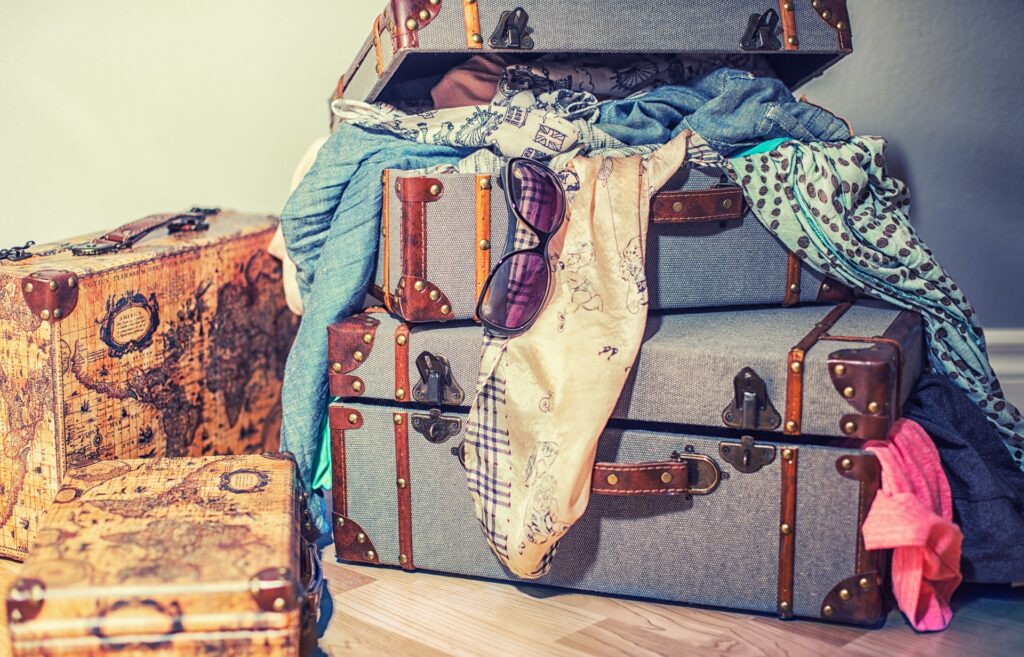 A pile of suitcases, clothes spilling out. How much baggage are you carrying? Is it time to let go?