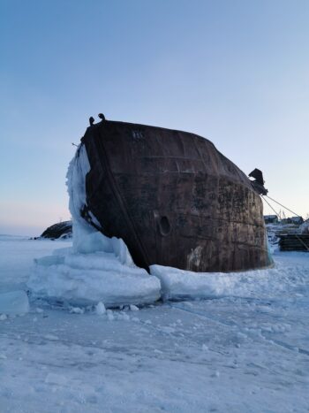 A ship's hull, stuck in the ice. Is this you? Stuck? Unable to move forward?