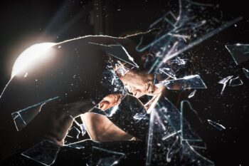 A broken mirror reflecting someone looking stressed. Is this anxiety for you?