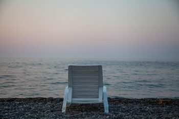 A beach chair facing the sea. A time for reflection