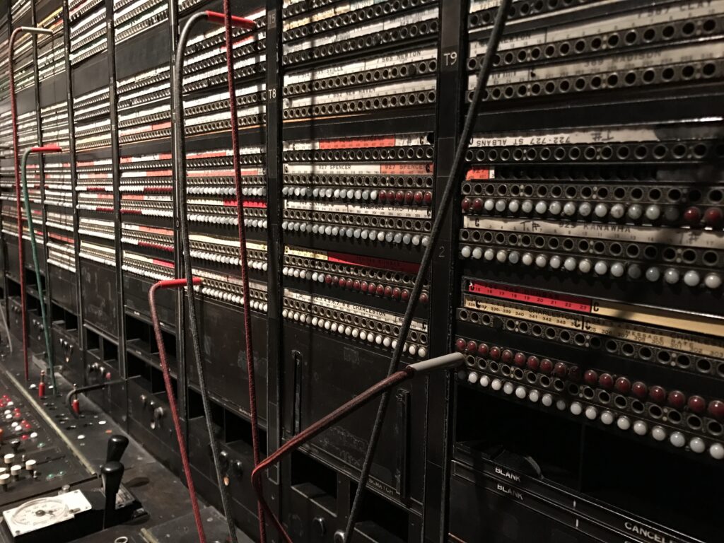 An old-fashioned switchboard, cables crossed