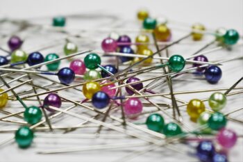 A pile of pins, with different colour heads. A scene of chaos